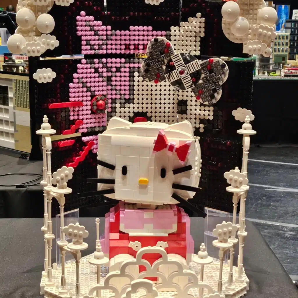 Phoebe's "I Dream of Terminator Kitty" MOC showing a 3-D Hello Kitty surrounded by clouds superimposed in front of an ominous mosaic of a partly robotic "Terminator Kitty" face.